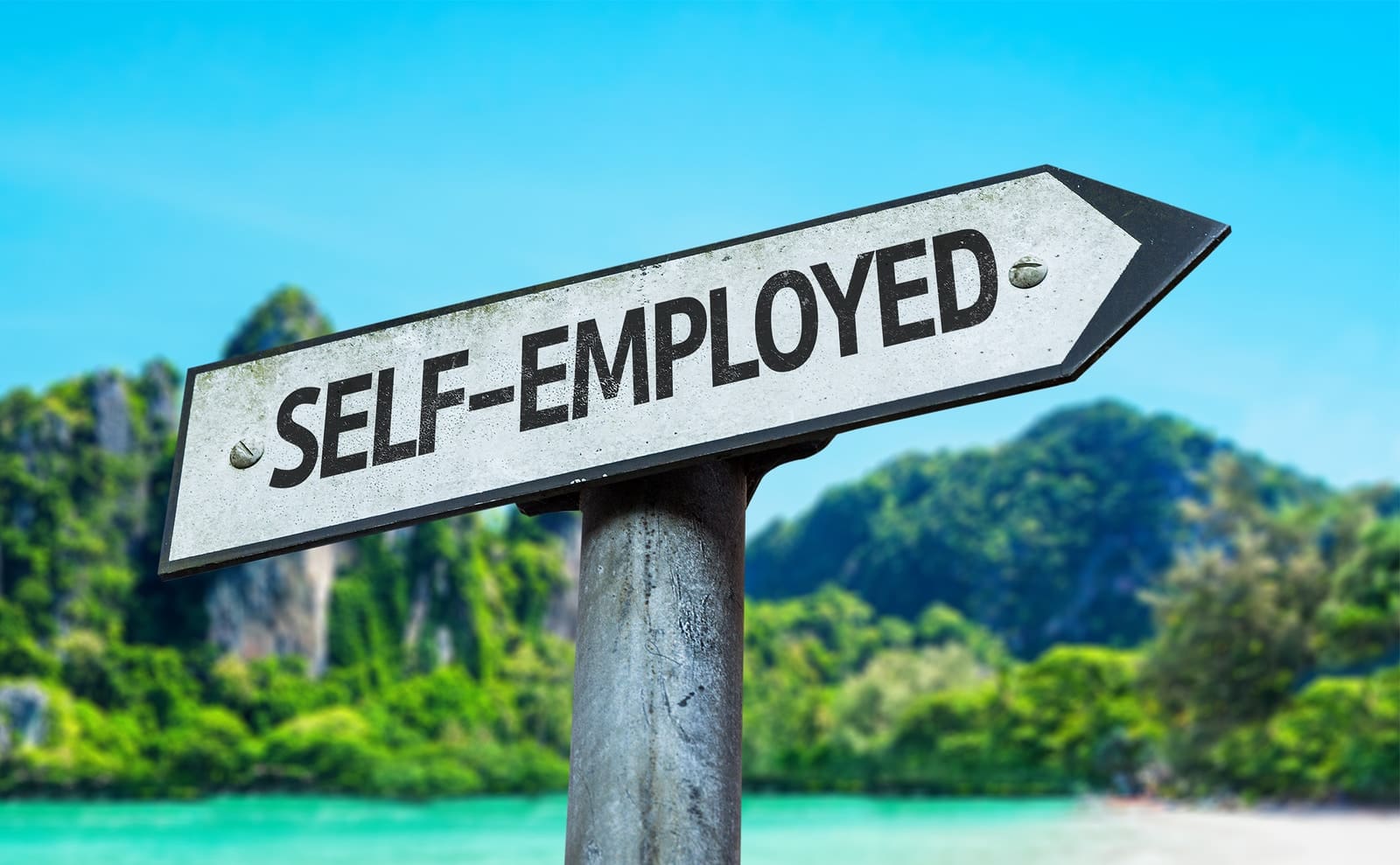Self-Employed sign with a beach on background